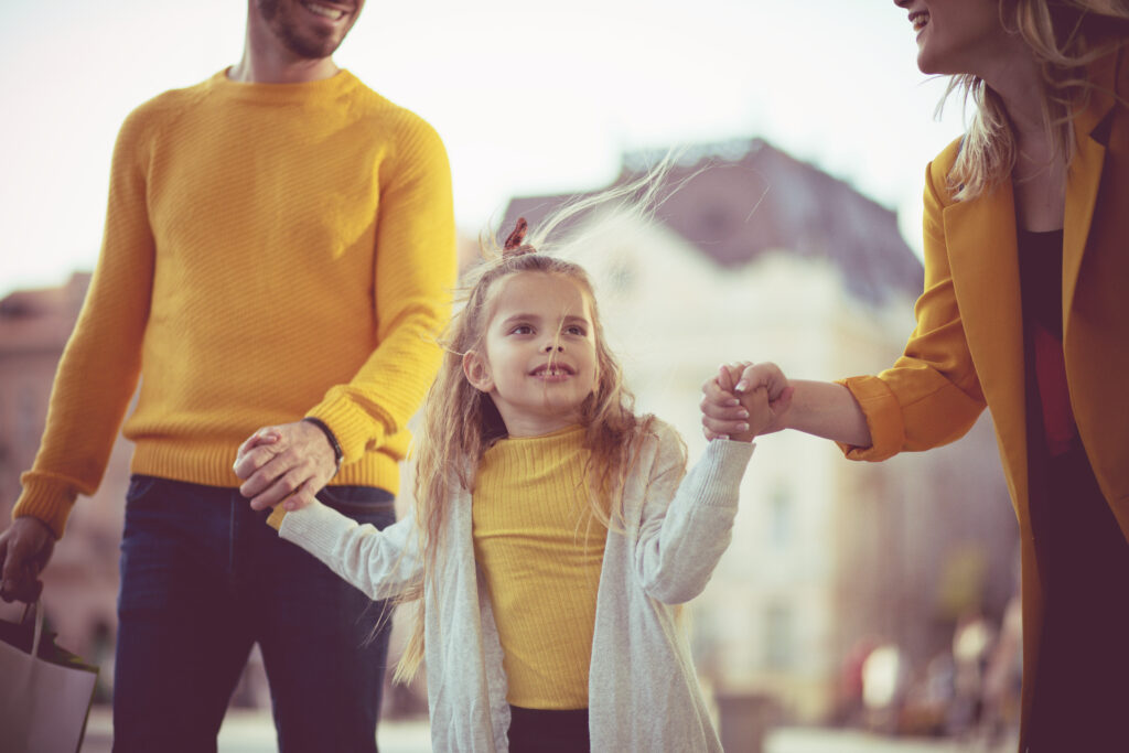 Family dressed in yellow, walking hand-in-hand