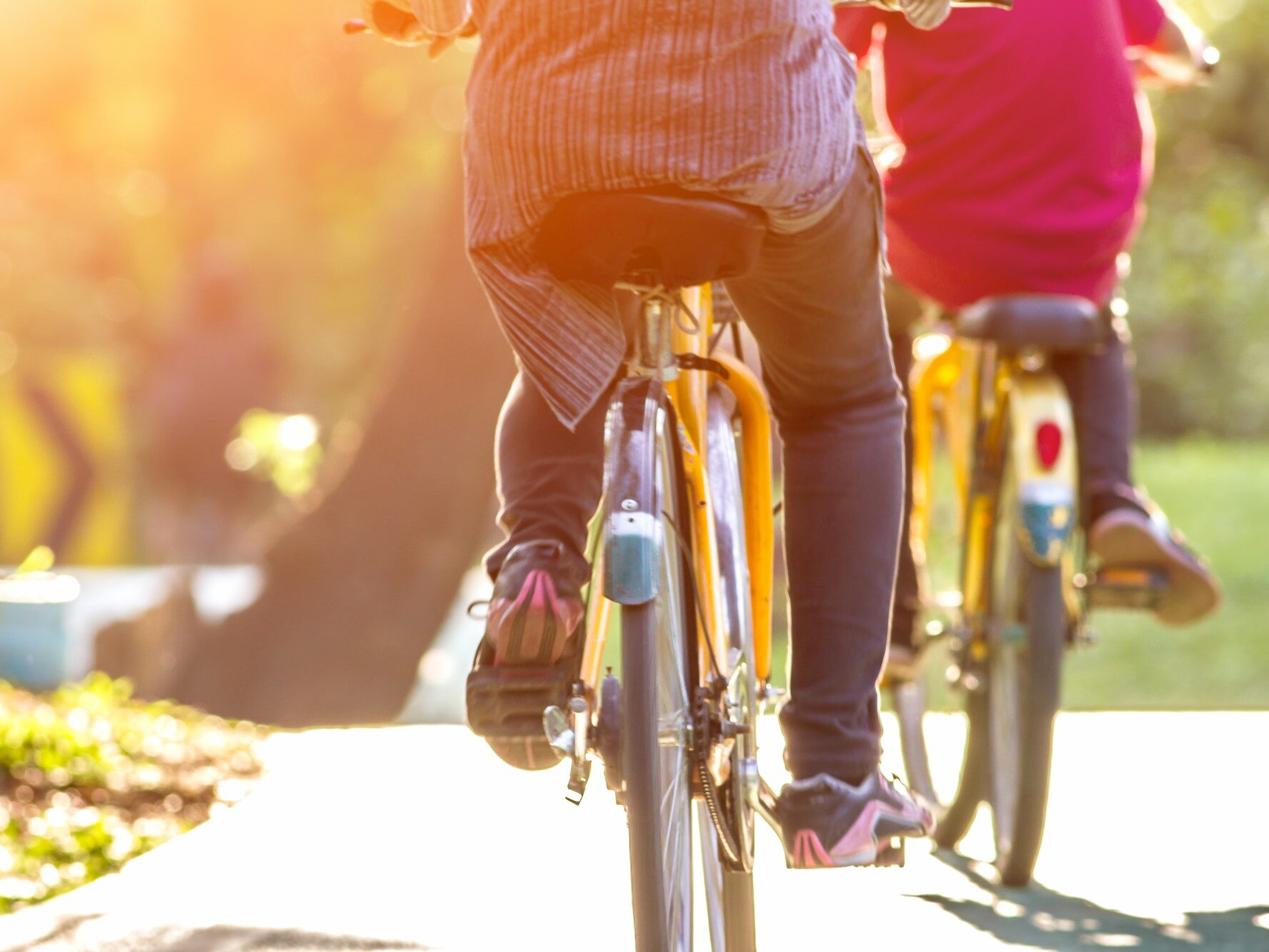 Two individuals riding bicycles