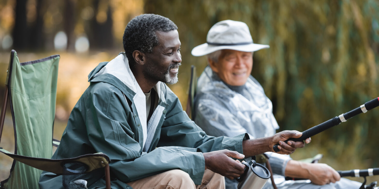 a couple of senior men fishing by lake